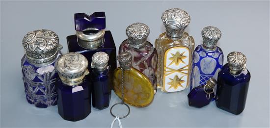 Ten assorted late 19th/early 20th century silver or white metal mounted coloured glass scent bottles, including floral painted yellow